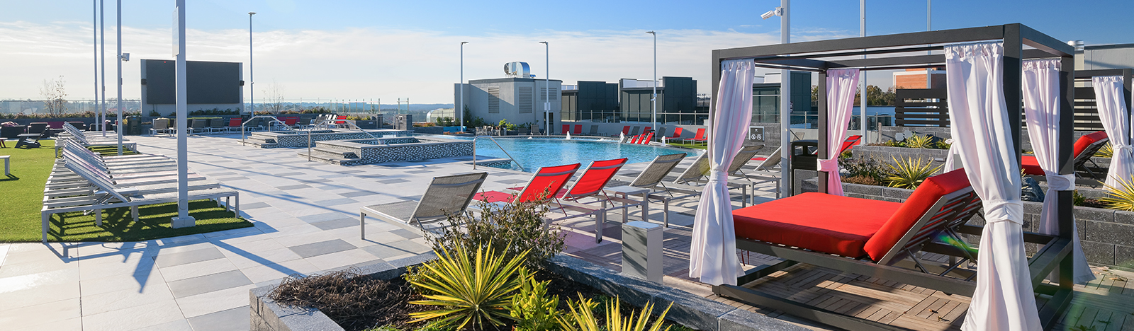 Resort style pool surrounded by lounge chairs and cabanas
