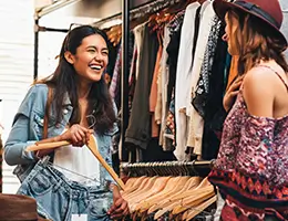 two young women shopping in a clothing store